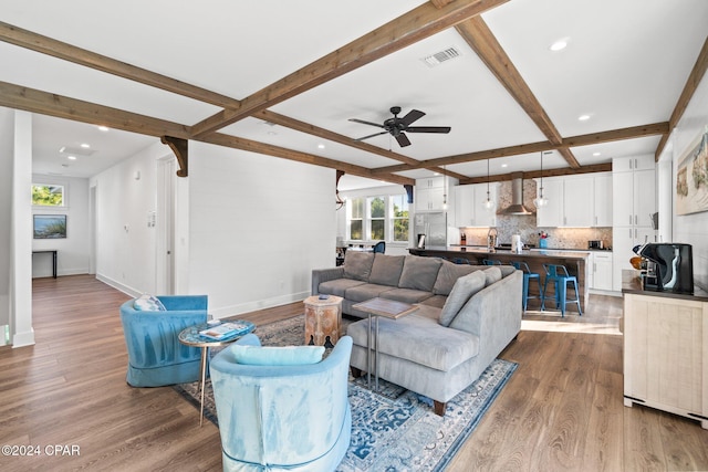 living room featuring wood-type flooring, ceiling fan, and beam ceiling