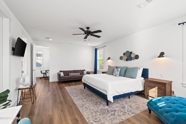 bedroom featuring ceiling fan and dark hardwood / wood-style floors