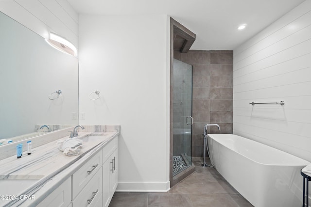 bathroom with tile patterned flooring, vanity, and separate shower and tub