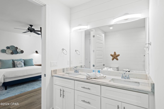 bathroom with ceiling fan, hardwood / wood-style floors, vanity, and toilet