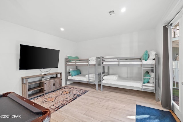 bedroom featuring pool table and light hardwood / wood-style flooring