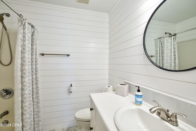 bathroom with vanity, wooden walls, a shower with curtain, and toilet