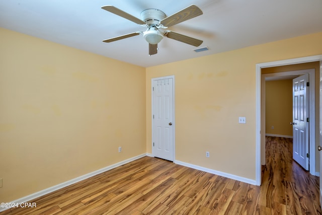 unfurnished bedroom featuring wood-type flooring and ceiling fan