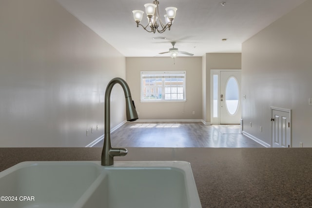 interior space with hardwood / wood-style floors, sink, and ceiling fan with notable chandelier