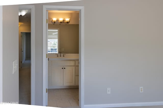 hallway with sink and light tile patterned floors