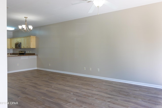 unfurnished living room with sink, hardwood / wood-style flooring, and ceiling fan with notable chandelier