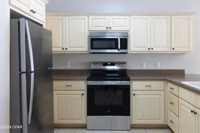 kitchen with light tile patterned flooring and stainless steel appliances