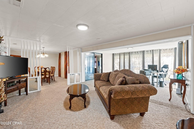 carpeted living room featuring a chandelier