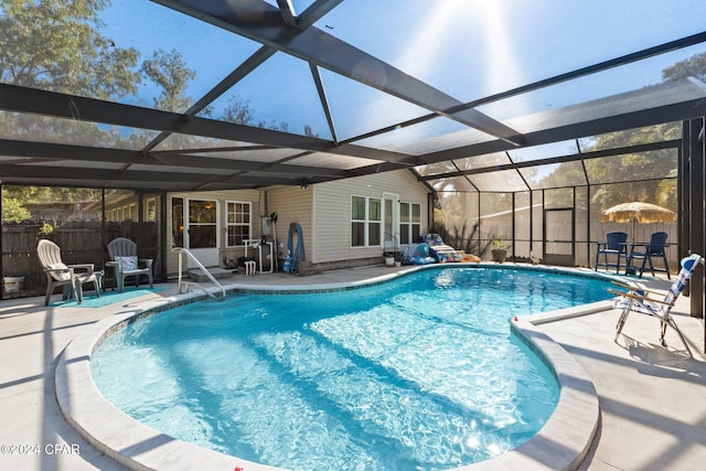 view of swimming pool with a patio, a lanai, and ceiling fan