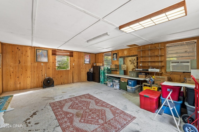 basement with a workshop area, wood walls, and cooling unit