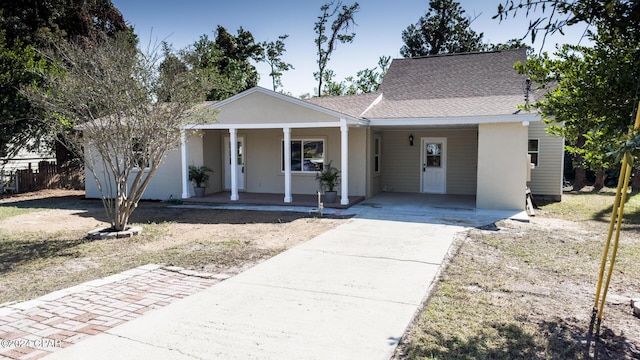 single story home with roof with shingles, fence, a porch, a carport, and driveway