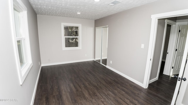 unfurnished room with dark wood-type flooring