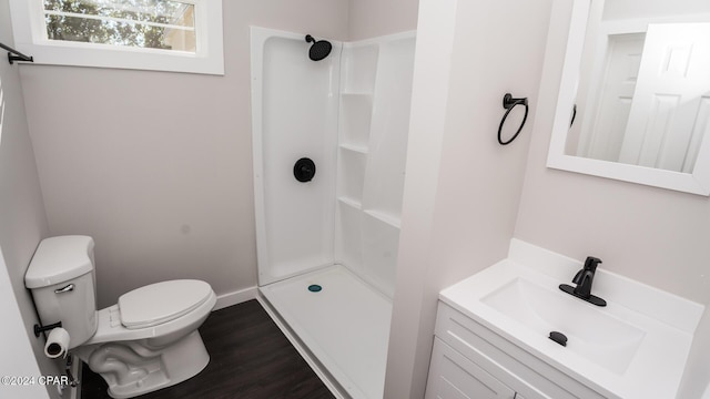 full bathroom with vanity, toilet, wood finished floors, and a stall shower