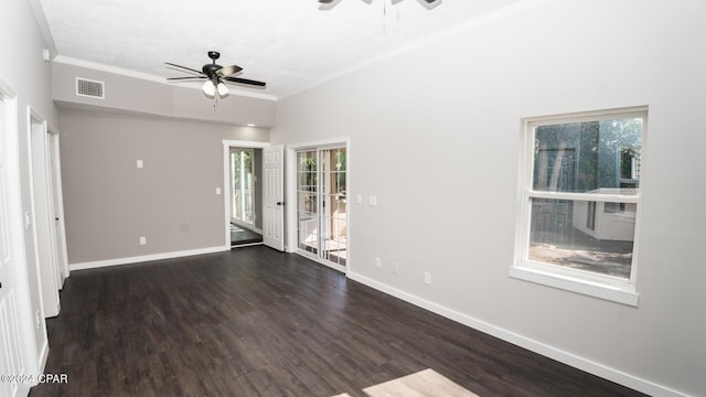 empty room featuring visible vents, plenty of natural light, wood finished floors, and ceiling fan