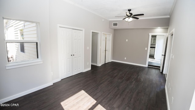 unfurnished bedroom with crown molding, baseboards, dark wood-style floors, and visible vents