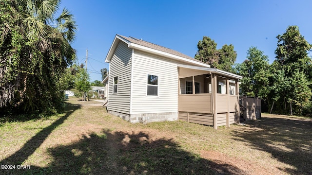 view of side of home featuring a lawn
