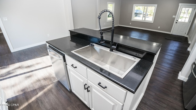 kitchen featuring sink, a kitchen island, stainless steel dishwasher, white cabinets, and dark hardwood / wood-style floors