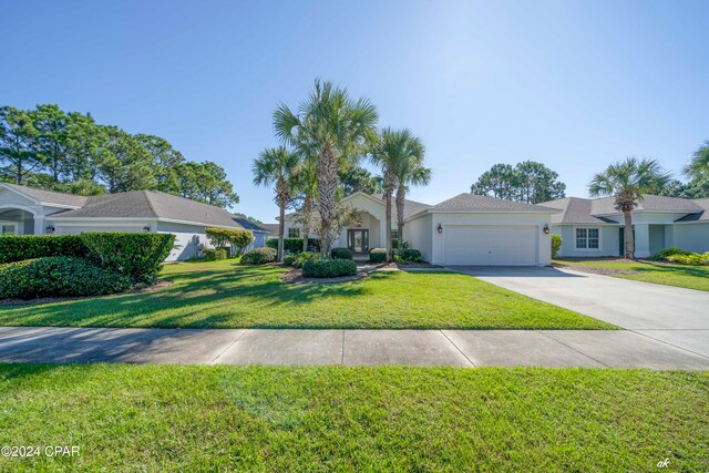 single story home featuring a front yard and a garage