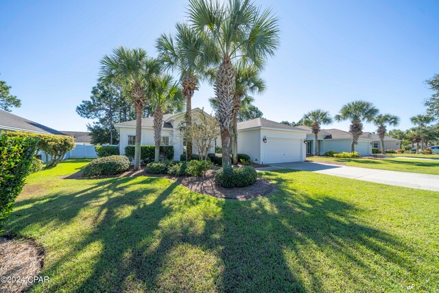 view of front of property with a front lawn and a garage