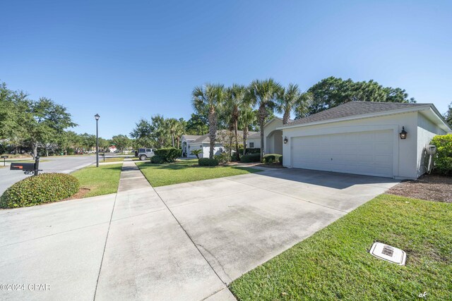 view of front of house with a front yard and a garage