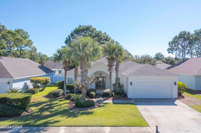 view of front facade with a front yard and a garage