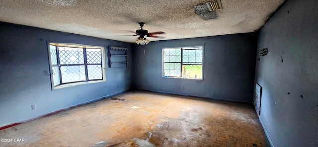 empty room featuring a textured ceiling and ceiling fan