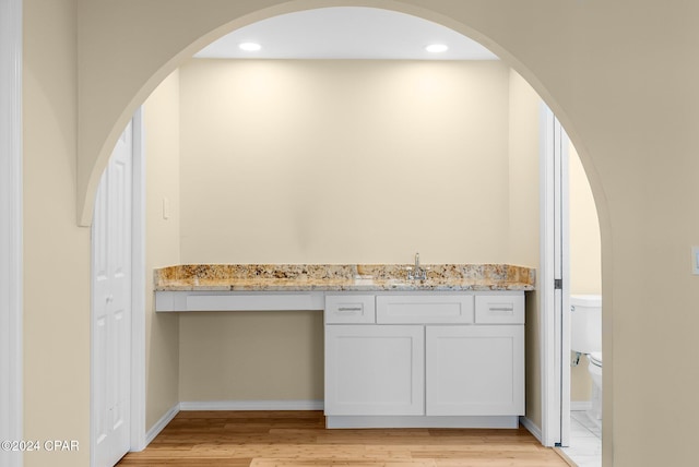 bathroom featuring toilet, hardwood / wood-style floors, and sink