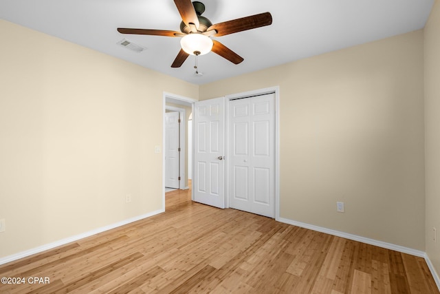 unfurnished bedroom featuring a closet, ceiling fan, and light wood-type flooring