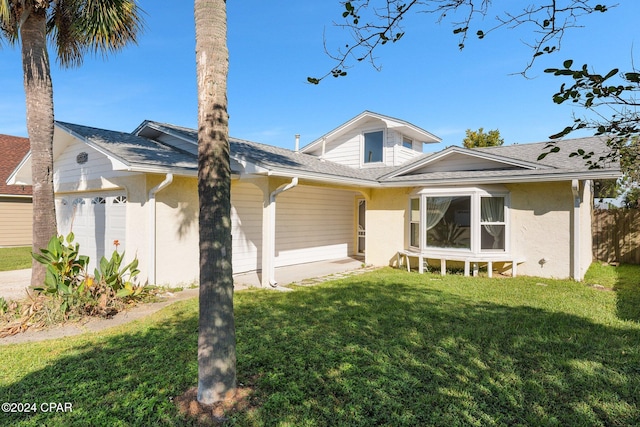 view of front of property featuring a front yard and a garage