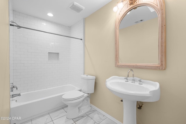 bathroom with toilet and tiled shower / bath combo