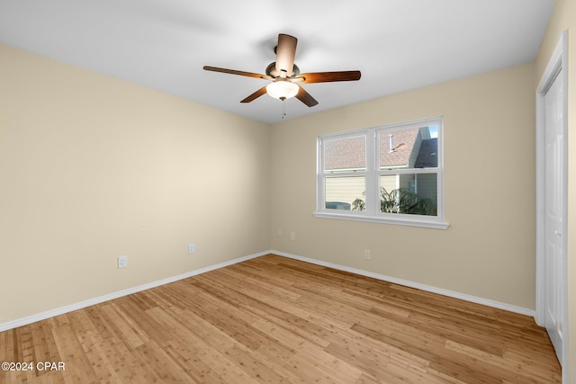 empty room featuring light hardwood / wood-style flooring and ceiling fan