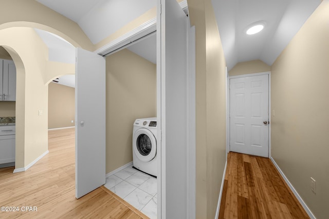 laundry room featuring light wood-type flooring and washer / clothes dryer