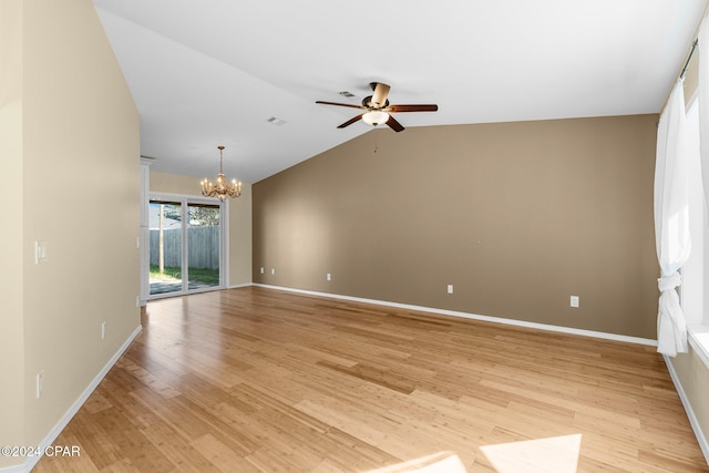 unfurnished room featuring light hardwood / wood-style floors, lofted ceiling, and ceiling fan with notable chandelier