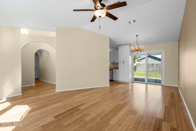 unfurnished living room with light hardwood / wood-style floors, lofted ceiling, and ceiling fan with notable chandelier