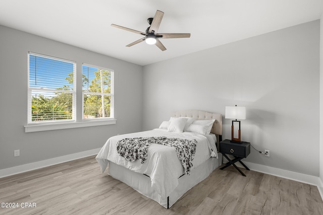 bedroom with ceiling fan and light wood-type flooring