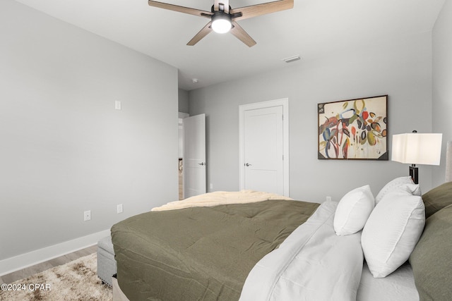 bedroom with wood-type flooring and ceiling fan