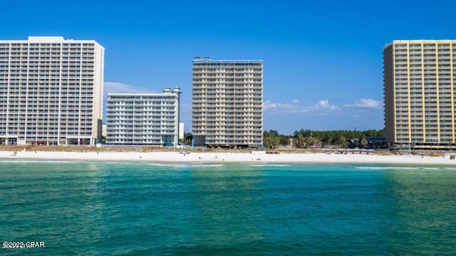 view of water feature featuring a view of the beach and a city view