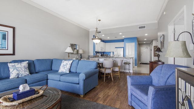 living area featuring recessed lighting, visible vents, wood finished floors, and ornamental molding