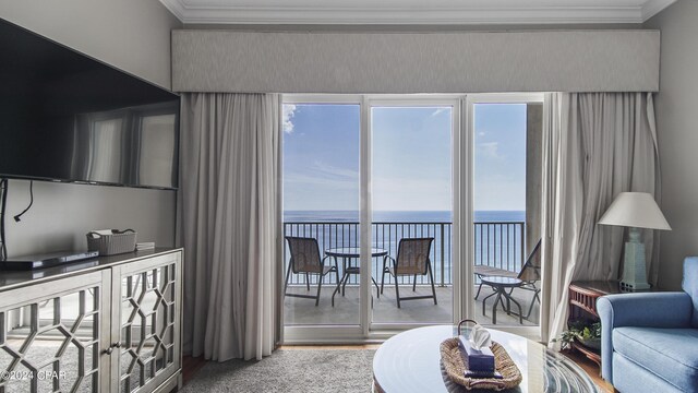 living area featuring a water view and ornamental molding