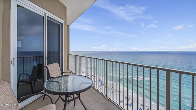 balcony with a water view and a beach view