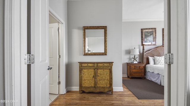 interior space featuring ornamental molding, baseboards, and wood finished floors