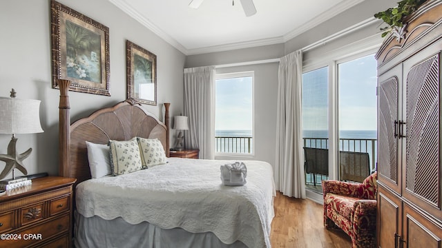 bedroom featuring a water view, light wood-style floors, access to outside, and crown molding