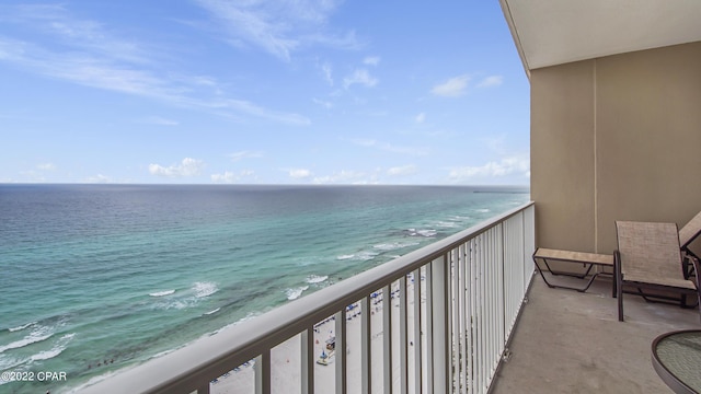 balcony featuring a water view and a view of the beach