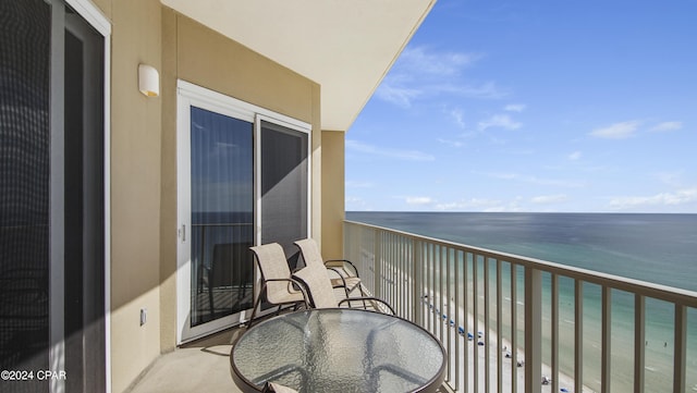 balcony featuring a water view and a view of the beach