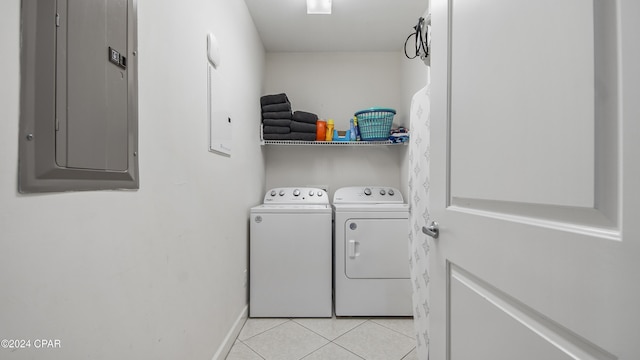 laundry area with laundry area, light tile patterned floors, electric panel, baseboards, and independent washer and dryer