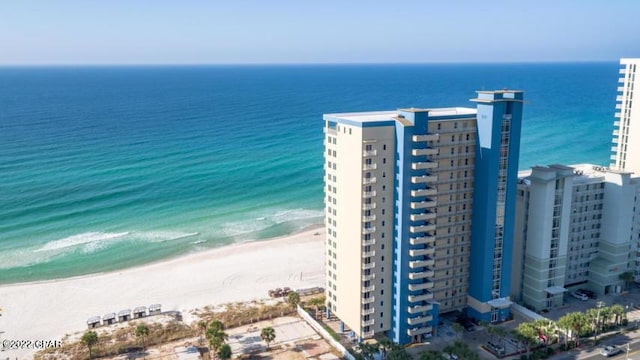 aerial view with a city view, a water view, and a beach view