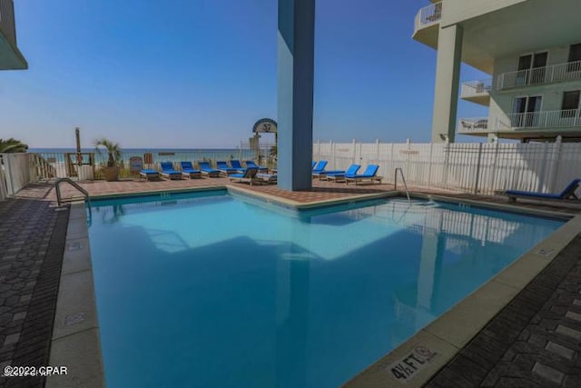 pool featuring a water view and fence