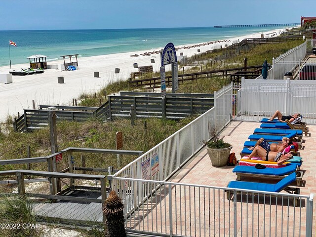 property view of water featuring fence and a view of the beach