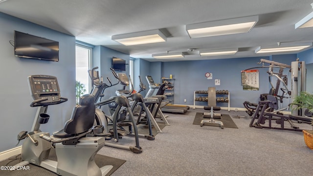 workout area with carpet flooring and baseboards