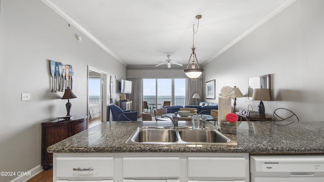 kitchen featuring ornamental molding, open floor plan, white cabinets, a sink, and dishwasher